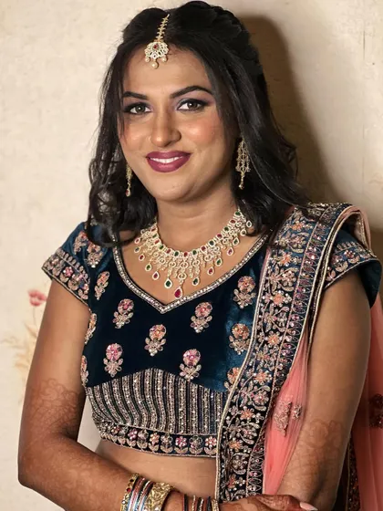A full look at Simran's engagement attire. The rich color of her lehenga and the dramatic eye makeup create a stunning combination.