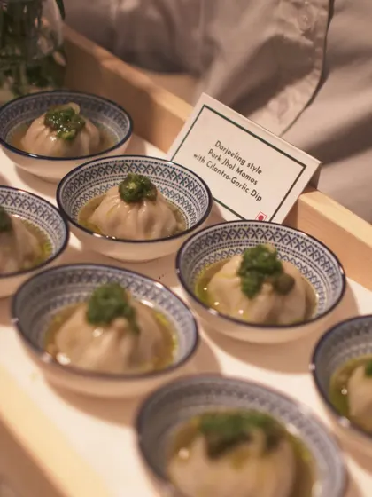 My version of Darjeeling-style Pork Jhol Momos. The delicate dumplings are served in a flavorful broth with a cilantro-garlic dip, perfect for a chilly evening.