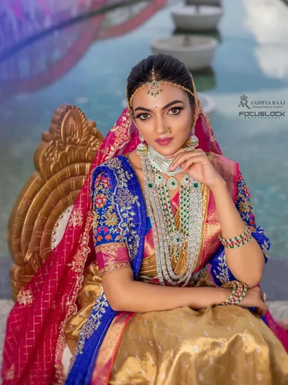 A fusion look combining a traditional half-saree with modern layered jewelry. This set features a diamond-simulant choker and a long haram with green beads, showing how my pieces can be styled for unique, contemporary events.