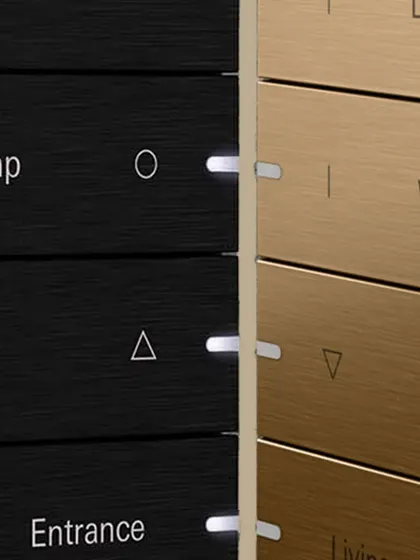 Gira keypads are available in multiple high-end finishes, such as the black and brushed bronze shown here. This allows us to match the technology to your interior design, ensuring a cohesive and luxurious aesthetic.