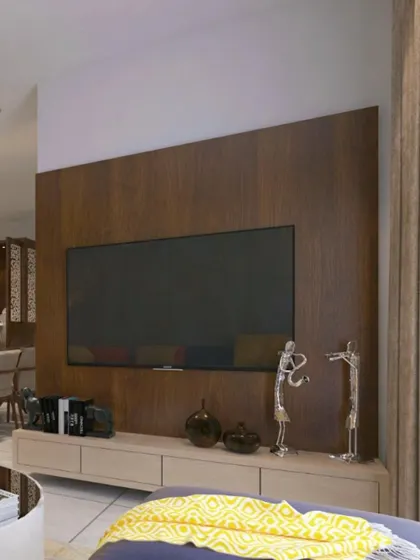A simple yet elegant media wall with a rich wood finish, providing a warm and minimalist backdrop for the television.