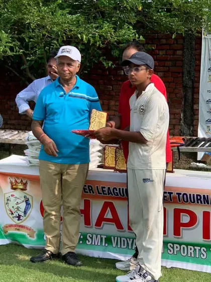A young player from Gyanti Cricket Academy being honored for his performance in the tournament.