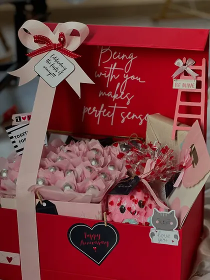 "Being with you makes perfect sense." This large red anniversary box is filled with chocolates and personalized touches, perfect for celebrating a milestone. It works beautifully for Valentine's Day too!