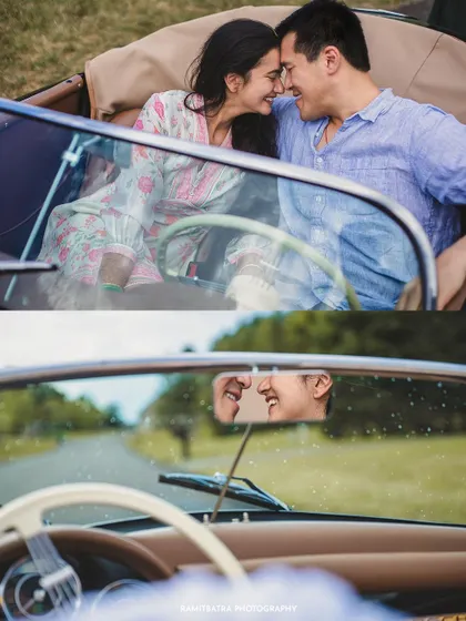 A creative shot of the couple reflected in the rearview mirror of their vintage car, capturing a moment of shared laughter.