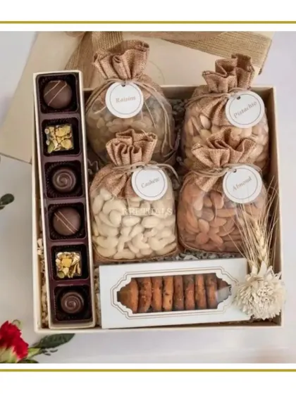 A classic gourmet Diwali hamper. This box is filled with an assortment of premium dry fruits like cashews, almonds, pistachios, and raisins, alongside artisan chocolates and cookies.