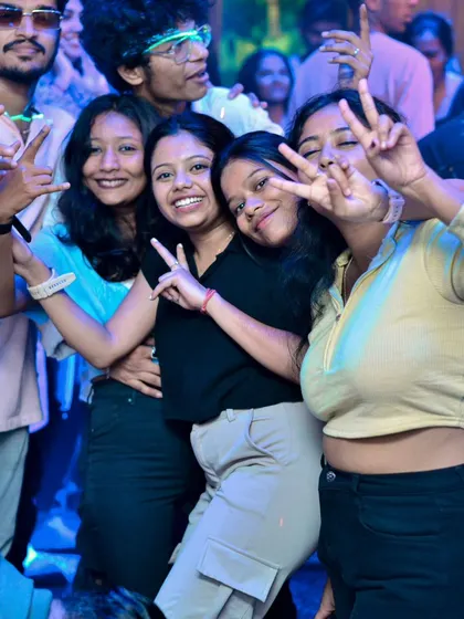 Peace signs and big smiles from a happy group on the dance floor. This is the positive energy I bring to every event.