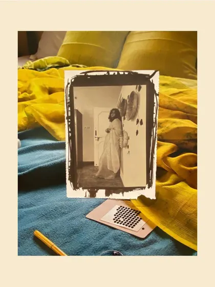 A salt print photograph from the "Inheritance" exhibition, capturing a personal moment with a vintage aesthetic.