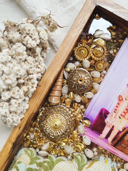 A detailed shot of the preserved golden kaleras and shells, showcasing the intricate and traditional elements captured in resin.