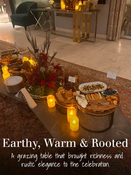 This grazing table was designed with an earthy, warm, and rooted theme. The rustic elegance of the wooden boards, candlelight, and rich colour palette brought a cozy and sophisticated feel to the celebration.