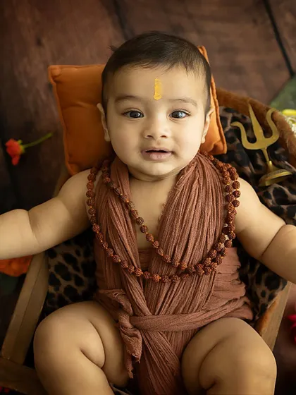 A calm and curious expression from our little Mahadev. He is taking in the whole studio environment with his wise eyes.