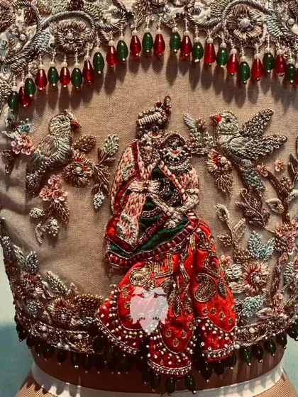 An exquisite net back bringing the timeless love story of Radha Krishna to life, with 3D parrots and a 3D skirt for Radha.