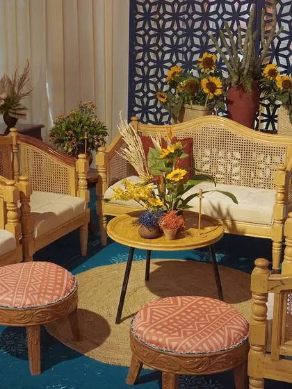 A pretty lounge setup from our Moroccan-themed event, featuring cane furniture and custom-printed linens on the pouffes for a cohesive and stylish look.