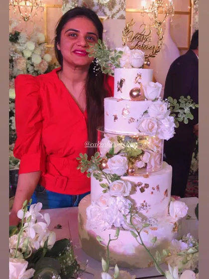 My first five-tier cake! This magical white and gold creation was for a 25th anniversary. It featured floating tiers with lights, delicate gold leaf, and a cascade of white roses. The top tiers were chocolate mousse and the bottom was classic pineapple.