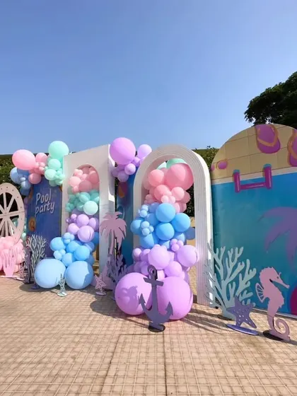 This angle showcases the layered backdrops and themed cutouts like seahorses and flip-flops, creating a rich, detailed scene.