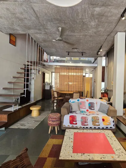 (Duplicate of 29) The double-height volume of my home-studio creates a sense of generosity and space, even on a small urban plot. The mezzanine level overlooks the main living area, maintaining a sense of connection between floors.