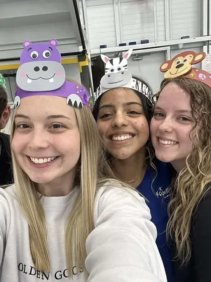 Coaches Yegor, Jaynee, Isabelle, and Madison smile for a selfie during our animal-themed camp activities.