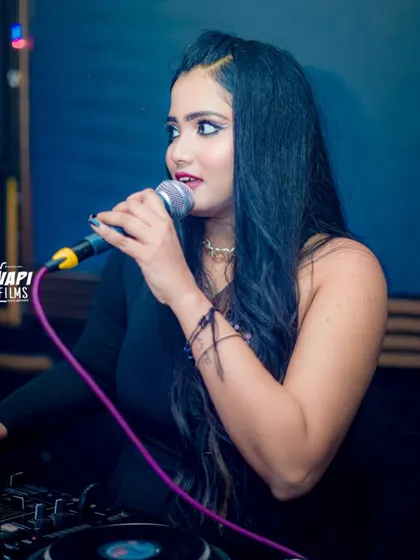 On the mic, hyping the crowd. I am not just a DJ, I am also an MC who engages with the audience throughout the night.