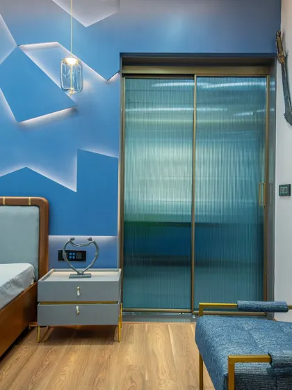 In this boy's bedroom, I used fluted glass sliding doors for the wardrobe. This adds a modern texture and partially obscures the contents, keeping the room looking tidy while adding a cool, contemporary design element.