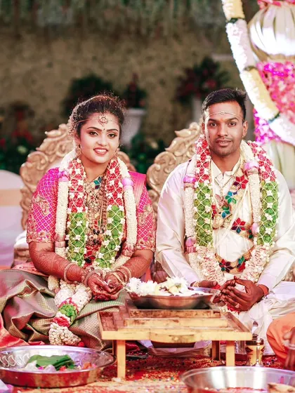 A formal portrait of the couple at their wedding mandap, ready to begin their life together.