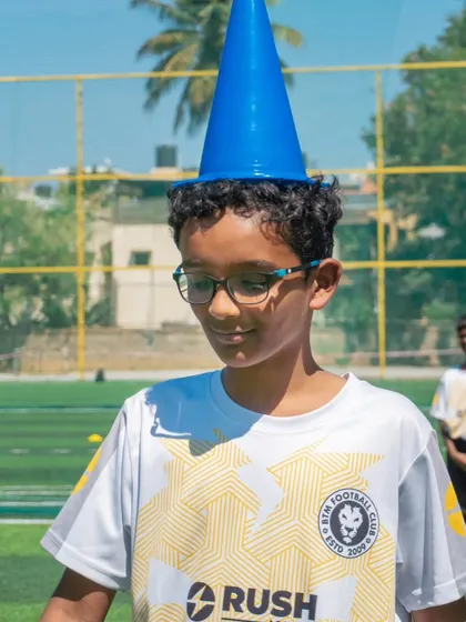 A young player having fun with a cone hat during the Annual Rush Festival. We encourage playfulness and creativity.
