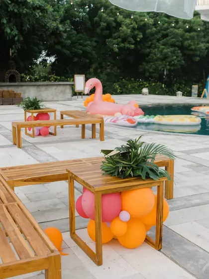 Our team setting up the poolside furniture and decor for a fun and festive party.