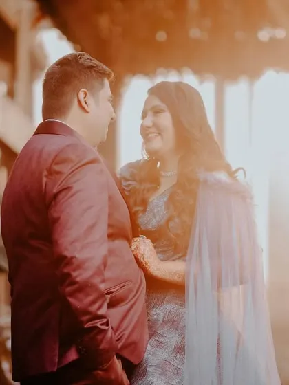 A soft-focus, romantic shot of a couple basking in the golden light of sunset during their pre-wedding session.
