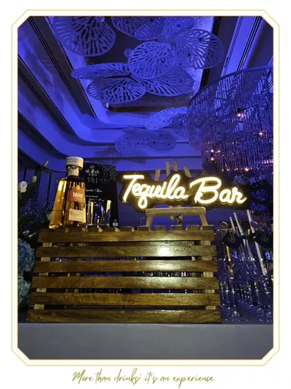 A rustic yet modern Tequila Bar featuring a wooden crate design and a neon sign. This setup is perfect for creating a dedicated tasting corner for spirits enthusiasts.