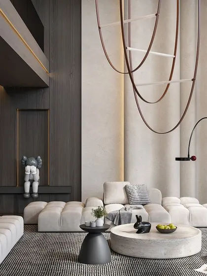 Here is another angle of a double-height living room, showing how we use dark wood paneling to create contrast and intimacy within a large volume. The custom sculptural light fixture and curated art pieces add a layer of personality and sophistication.