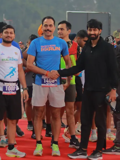 Shaking hands with a participant at the starting line. I make it a point to connect with runners and create a welcoming and encouraging atmosphere.