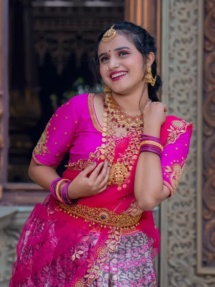 A joyful shot showcasing a complete half-saree look with our layered temple jewellery, including a hip belt and bangles.
