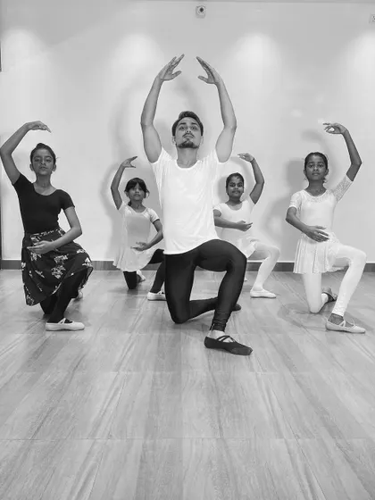 A group of young ballerinas in a synchronized pose with me during a class. These photos show the discipline and coordination we build in our ballet program.