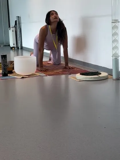 Demonstrating Cat-Cow pose (Marjaryasana-Bitilasana). This is a foundational movement for warming up the spine and is easily adaptable for all levels.