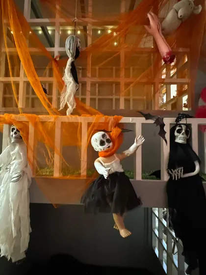 I pay attention to every spooky detail. From hanging ghouls to creepy crawlies and orange drapery, the entire space is transformed into a fun and festive haunted house.
