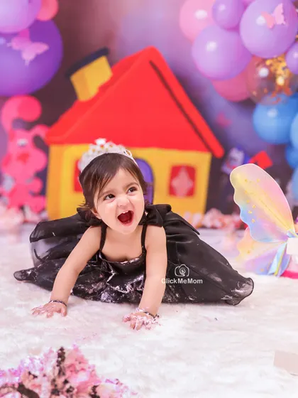 Let the mess begin. A first birthday cake smash is all about letting go and embracing the chaos, and this little princess's joyful expression says it all.