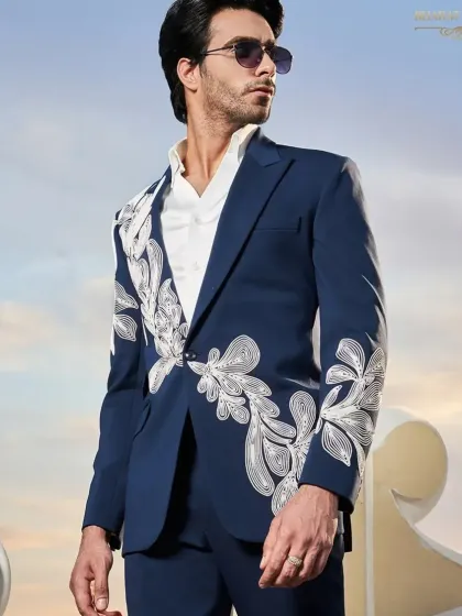 A modern navy blue suit with abstract white embroidery, perfect for a stylish groom's reception.