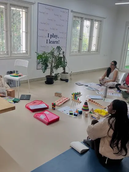 In this training session, I am explaining a concept using a presentation while the educators have the physical learning aids right in front of them. This blend of visual instruction and hands-on practice ensures a deep understanding of early numeracy skills.
