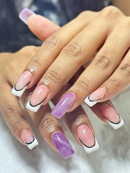 This trendy design features a sharp, graphic French tip outlined in black. A pop of purple cat-eye gel on the accent nail adds a surprising and cool element.