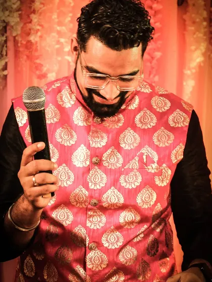Looking down at my mic, probably thinking of the next joke to crack. These are the small, in-between moments during a high-energy sangeet that I cherish.