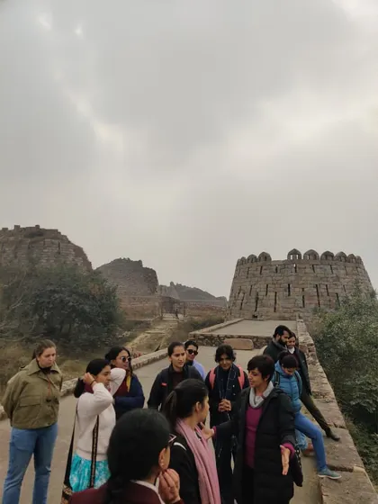 A close-up of our group on the fortifications of Tughlaqabad. The sloping walls are a characteristic feature of Tughlaq architecture, designed for defensive strength.