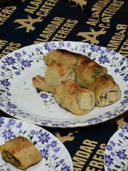 Our savory chicken rolls, perfectly cooked and plated, ready to be enjoyed by our guests.