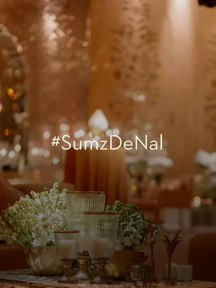 A title card for the event, set against the soft, candle-lit glow of the decor, perfectly capturing the mood of the evening.