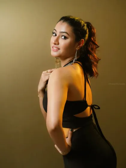 A confident and engaging portrait. The warm background and direct eye contact make this a very effective headshot for commercial or theatrical use.