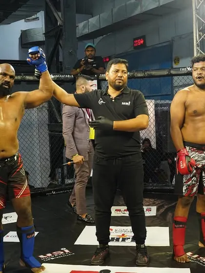My hand raised in victory. This is the moment every fighter trains for, a clear and decisive win inside the cage.