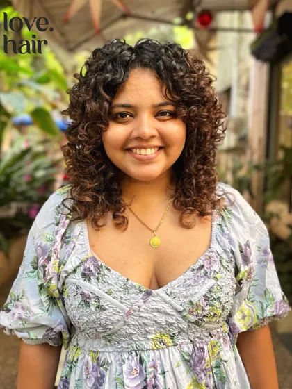 Cute girls, curly hair. This client is all smiles with her new curly cut, which features face-framing layers and beautifully defined curls.