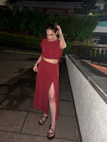 A candid walking shot in the red co-ord, showing how the fabric moves.