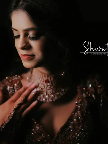A serene and beautiful close-up of the bride on her engagement day. The soft lighting highlights her features and the intricate details of her necklace.