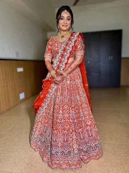 A full-length shot of the client in her gorgeous orange lehenga. She looks like royalty, ready to celebrate her child's special milestone.