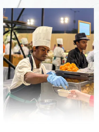 A chef at one of my live counters, serving a guest with professionalism and care. I ensure my team is not only skilled in cooking but also in providing a warm and welcoming service experience.