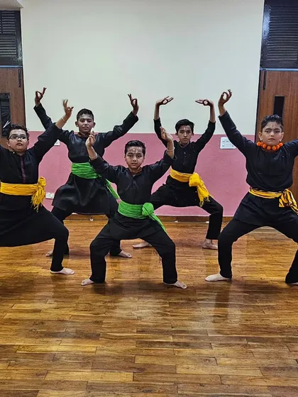 The boys' Chhau group in a powerful opening stance, ready to begin their energetic dance routine.
