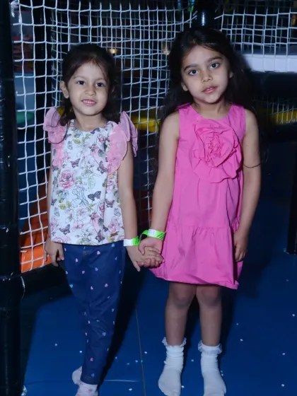 Two best friends hold hands during a Paw Patrol themed birthday party, ready for a ruff-ruff rescue adventure.